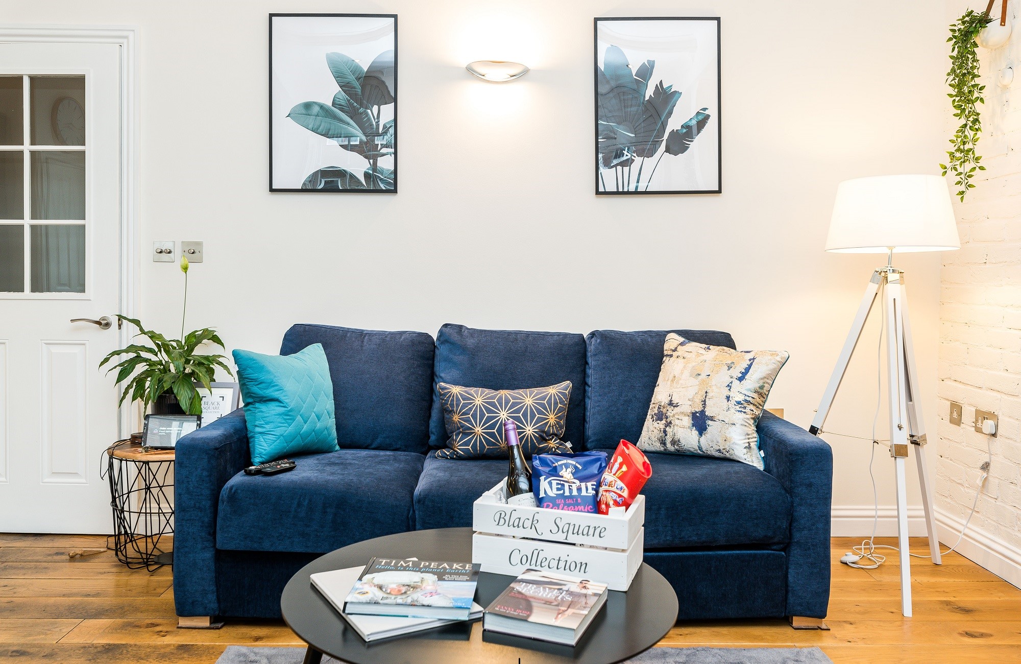 <img src="ana.jpg" alt="blue sofa in living room blacksquare apartments"/>