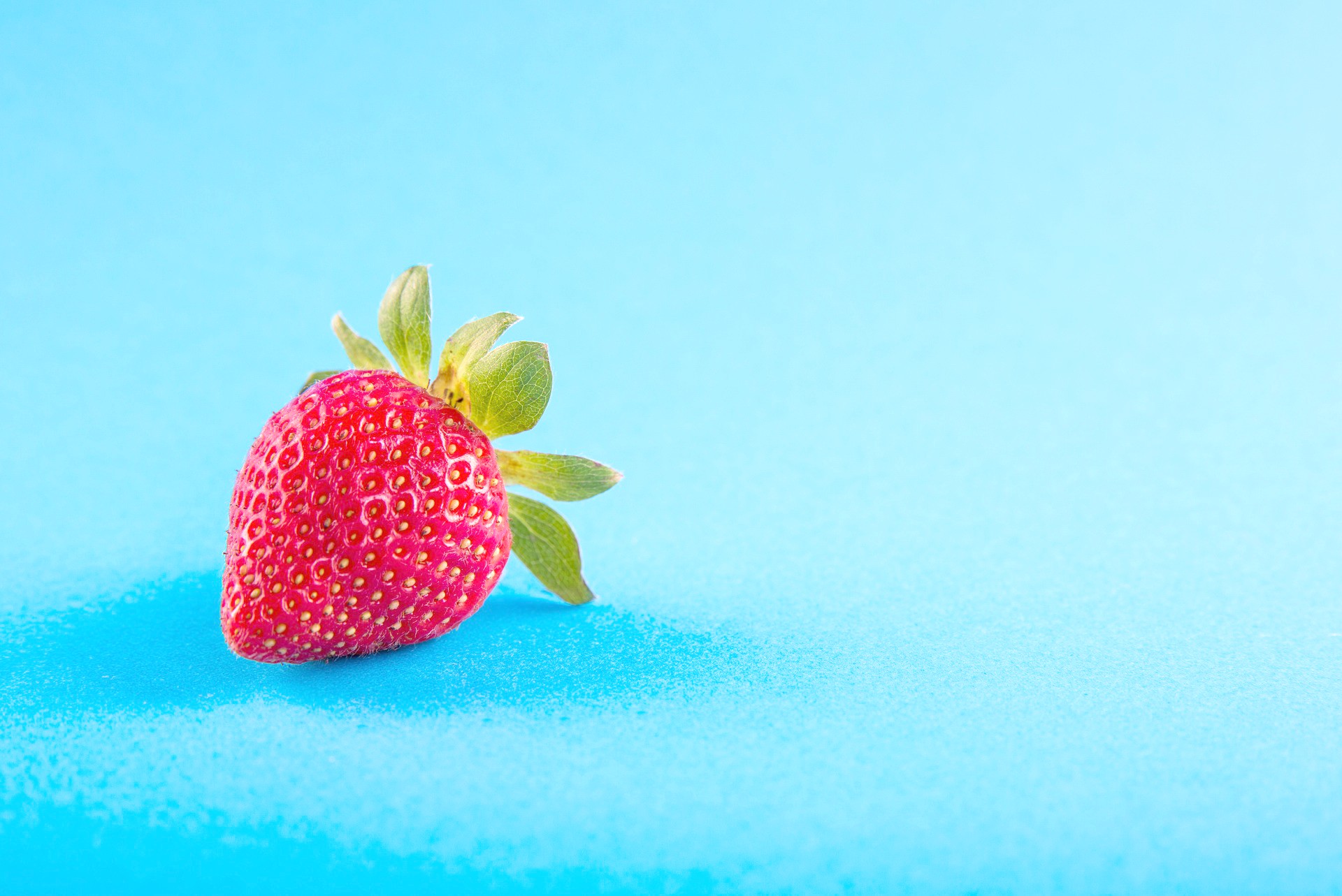 <img src="strawberry.jpg" alt="strawberry on blue background"/> 