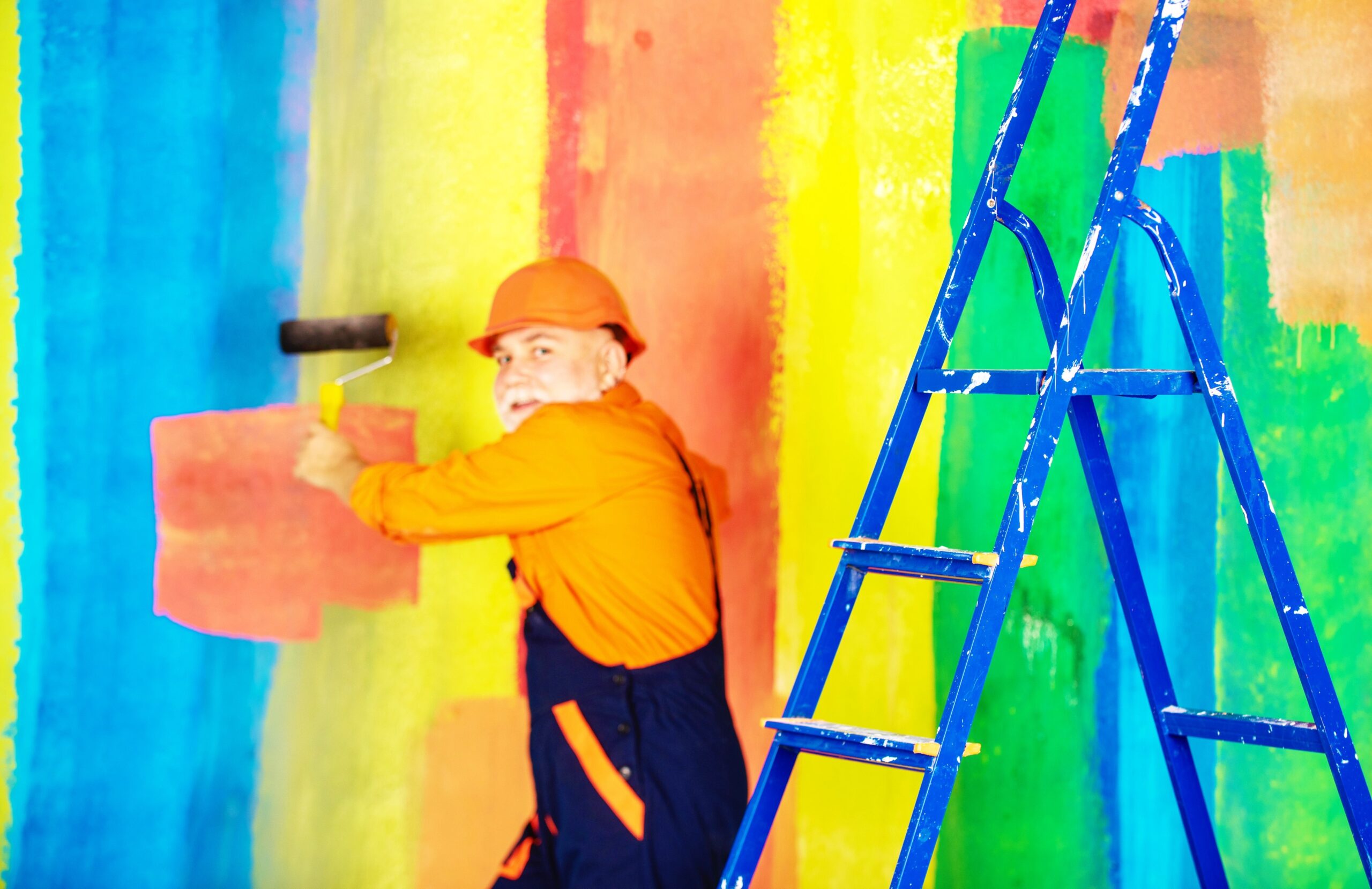 <img src="person.jpg" alt="Person painting a rainbow wall"/>