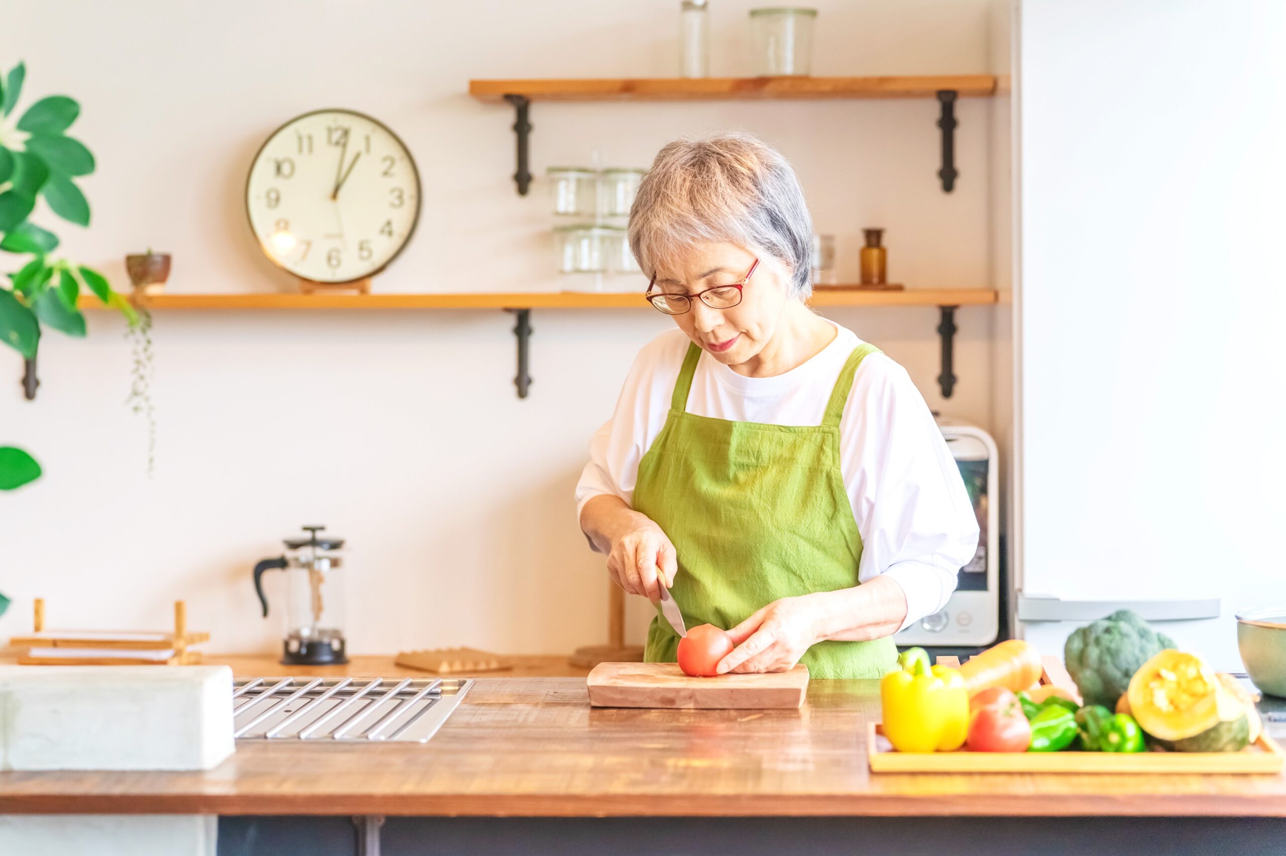 <img src="elderly.jpg" alt="elderly woman cooking healthy dinner"/>