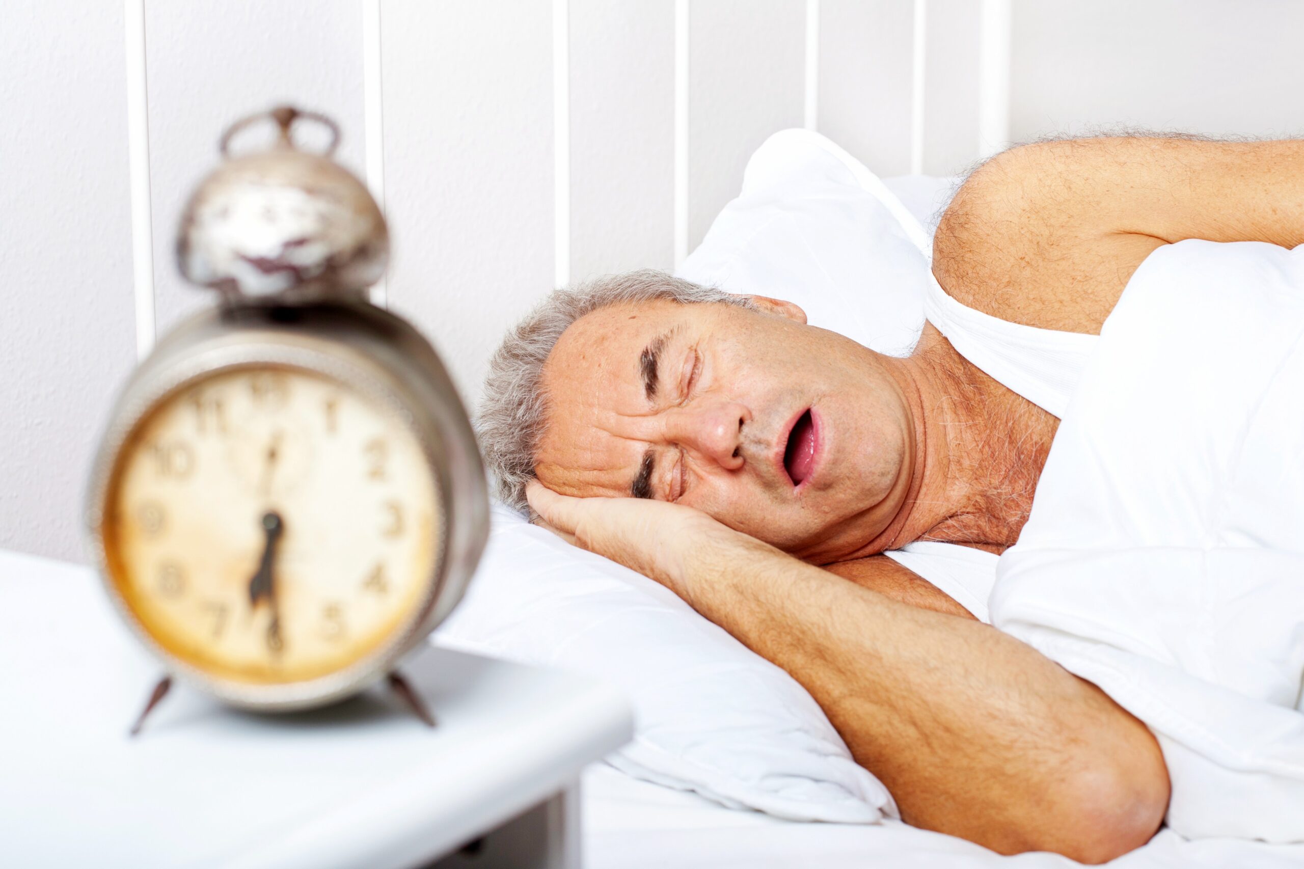 <img src="man.jpg" alt="man snoring in bed with clock"/>